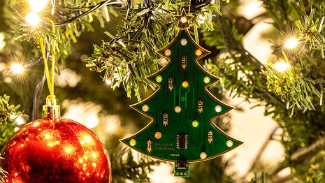 A christmas tree with an christmas tree LED ornament hanging